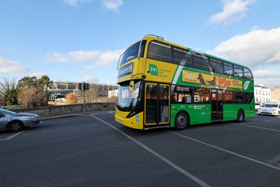 Image of a Dublin Bus from the side, yellow and green bus colour.